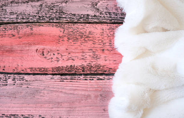 istock Decorative white fur on pink wooden planks. copy space 1292898465
