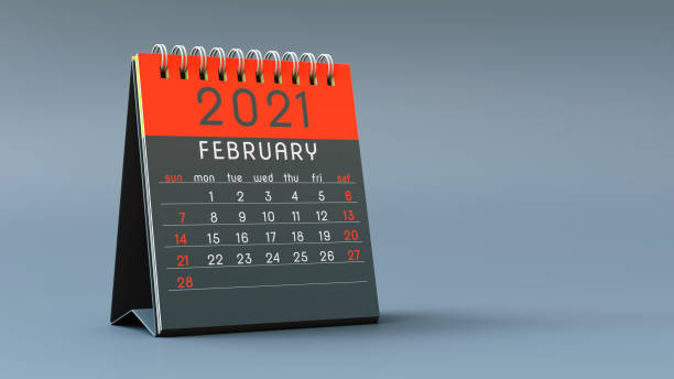 istock 2021 calendar notebook with February page in red colors, standing on a light gray background 1292898632