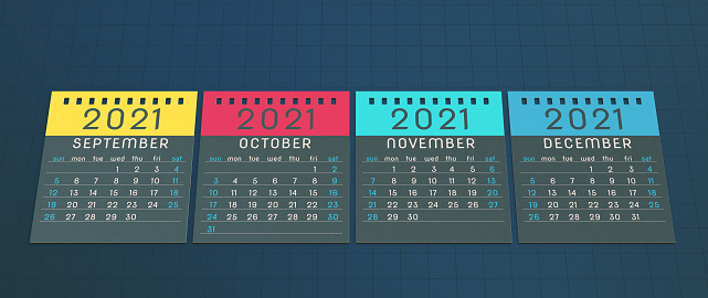 A row of multi-colored 2021 calendar note pad pages lying on a grid background