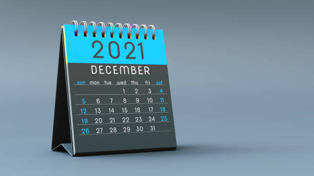 istock 2021 calendar notebook with December page in blue colors, standing on a light gray background 1292899383