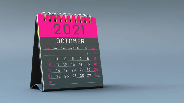 istock 2021 calendar notebook with October page in magenta colors, standing on a light gray background 1292899631