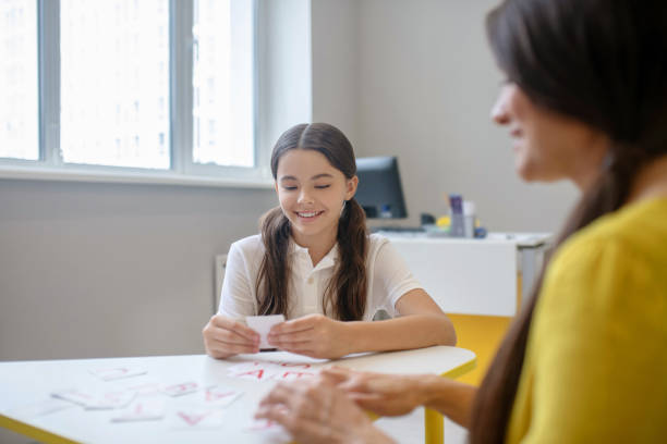 istock Involved girl playing at table with cards 1292900007