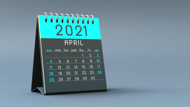 istock 2021 calendar notebook with April page in blue colors, standing on a light gray background 1292900135