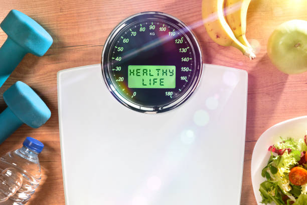 istock Healthy life concept with weighing scale with message and objects 1292904190