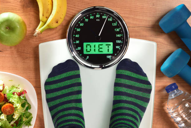 istock Person weighing with message diet and elements for healthy life 1292904199