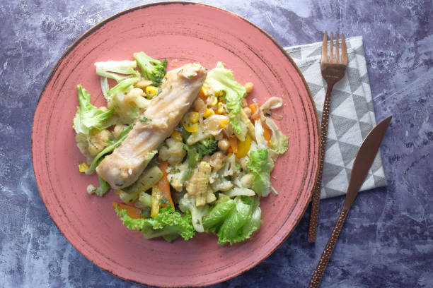istock Fish fillet with vegetables on plate close up 1292907245