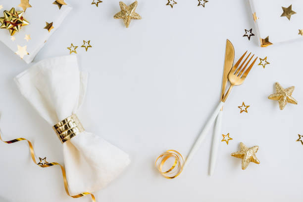 istock Christmas and New Year holiday table setting on white background with golden decorations. 1292909624
