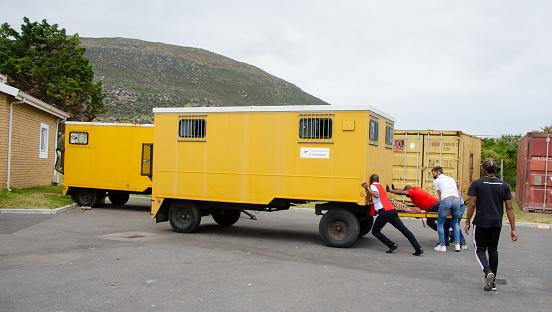 12.23.2020 Men pushing a trailer, this trailer was loaded full of gifts for the victims of the fire in Masiphumelele