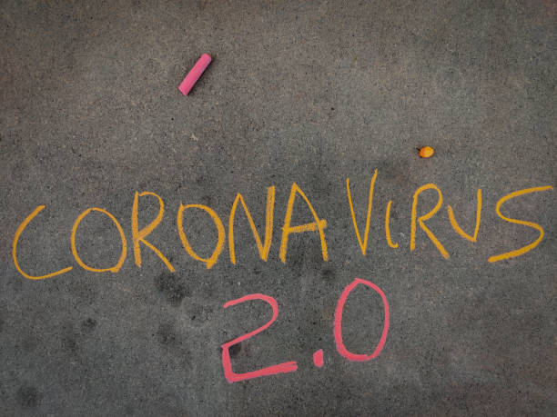 istock The inscription text on the grey board, Corona virus 2.0 Using color chalk pieces. 1292918048