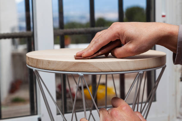 istock The hands of a carpenter sanding a stool 1292918644