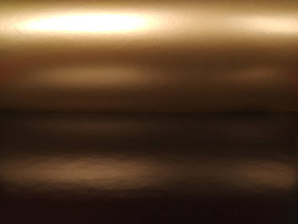 Gradient on a brown background. Horizontally folded shiny paper or foil with overflow and glare. Soft brown and beige color. Mysterious radiance. Northern Lights. Luxury fabric. Metallic gold glitter