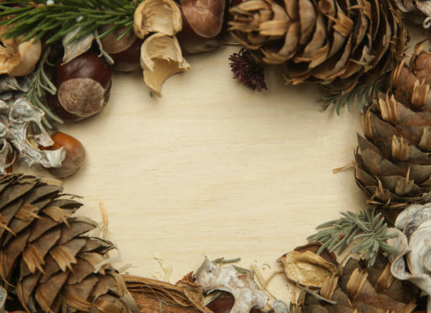 istock Autumn frame with leaves, chestnuts, acorns, pine cone on white with copy space on wooden background 1292920727