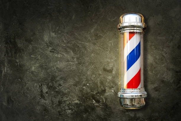 istock Barber pole. Barbershop pole on a textured background with copy space. 1292922257