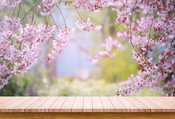 istock Wooden board with flower background. Empty wooden table with copy space 1292928571