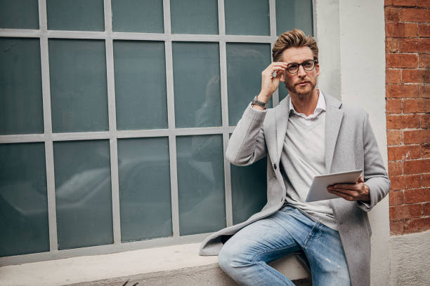 istock Handsome man using digital tablet on the street 1292928707