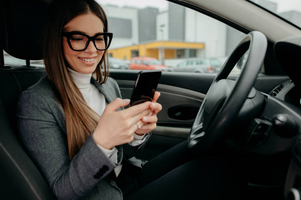 istock Business Woman driver using a smart phone 1292929373