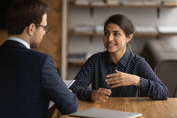 istock Confident Indian woman talk with employer at interview 1292931044