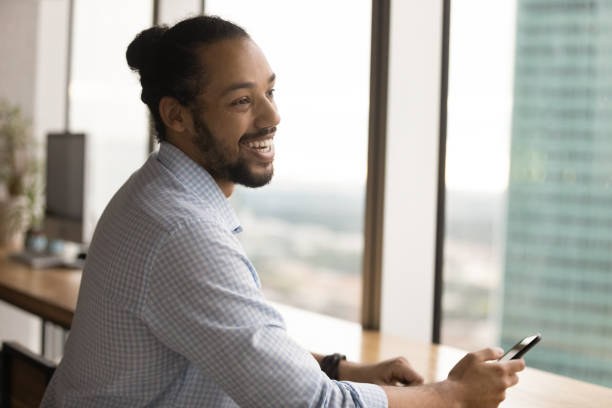 istock Overjoyed biracial man have pleasant talk with colleague 1292931101
