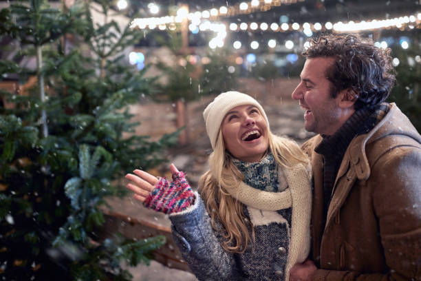 istock Girlfriend and boyfriend choosing a Christmas tree together 1292934040