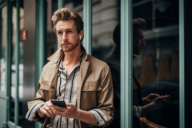 istock Modern man using phone on the street in city 1292934262