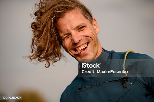 istock Portrait of cheerful man who grimaces and shows his tongue. 1292935259