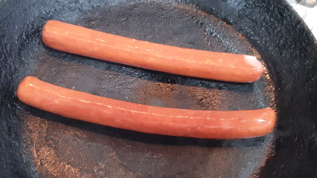 Frying two sausages