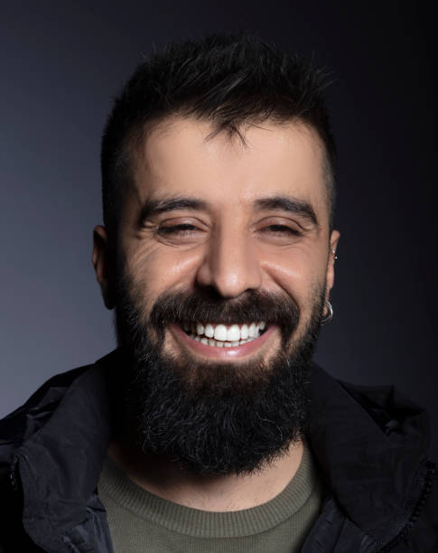 istock Handsome man with beard looking at camera and laughing. 1292937545