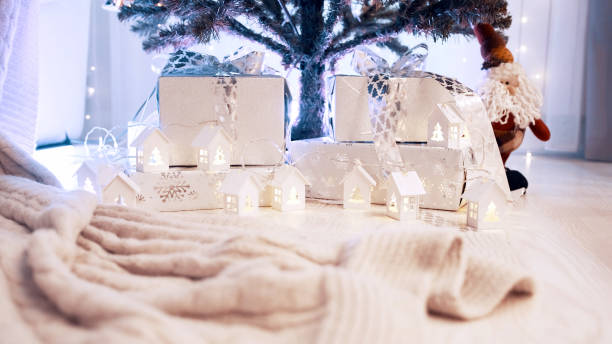 istock Christmas gifts under the tree with a toy gnome 1292937611