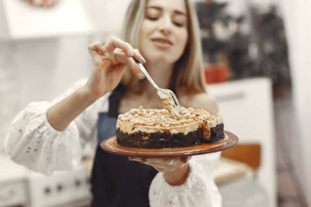 istock Young woman holding self-made cake in the kitchen 1292939822