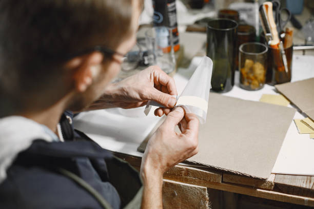 istock A man sticks stickers on glasses 1292940009