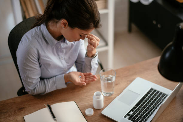 istock Young businesswoman drinking medicine pill. 1292942135