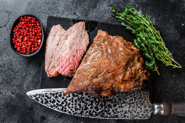 istock Roast beef tri tip steak bbq. Black background. Top view 1292942168
