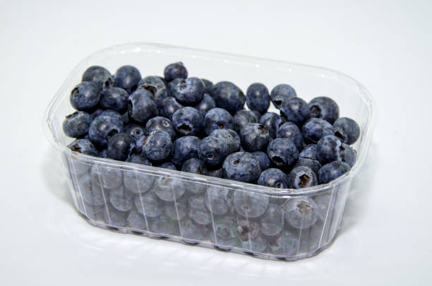 istock Fresh organic blueberries in a transparent plastic packaging on a white background 1292942218