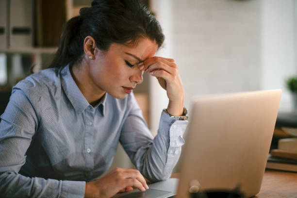 istock Tired businesswoman in office. 1292943571