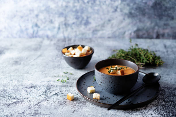 Sweet potato soup with croutons and thyme leaves Sweet potato soup with croutons and thyme leaves. toning. selective focus food styling stock pictures, royalty-free photos & images