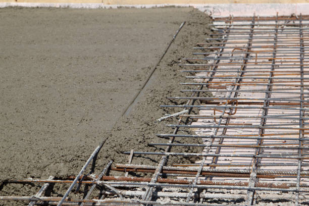 istock pouring concrete into prepared place with reinforced metal frame 1292945646
