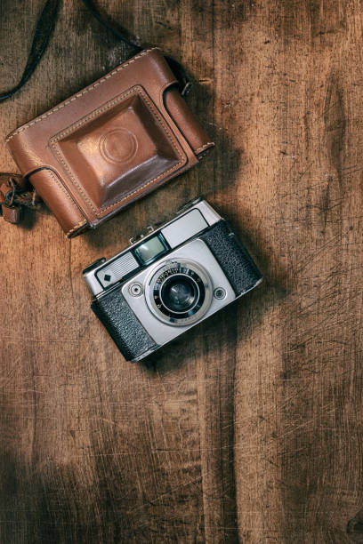 istock Still life flat lay retro camera on wooden background 1292946583