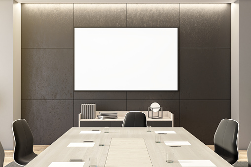Spacious meeting room with furniture and empty poster on gray wall. Presentation concept. Mock up, 3D Rendering