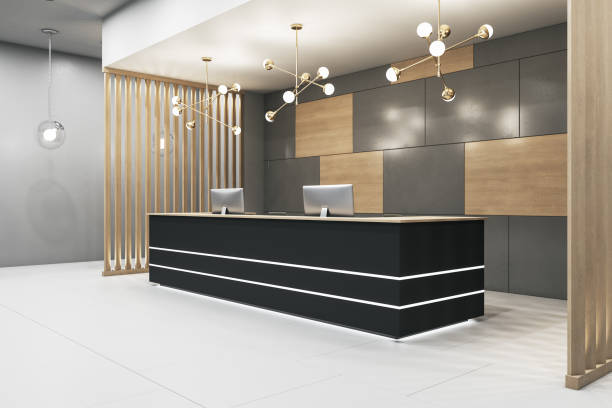 istock Luxury office lobby with black reception desk and two computers. 1292947874