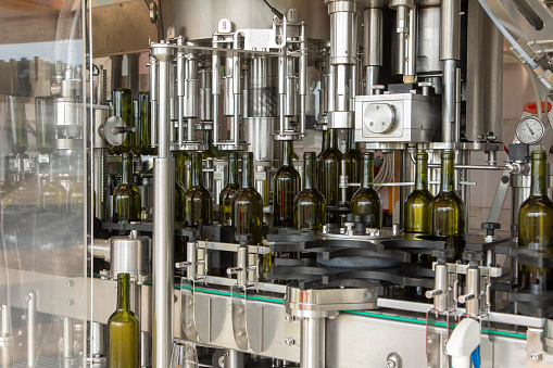 Bottling of wine in a winery by a mobile bottling line. Modern technology, filling takes place automatically.