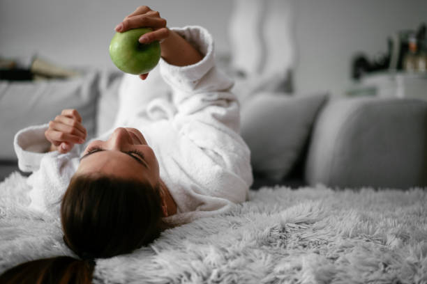 istock Pretty young girl eating fresh apple. 1292950992