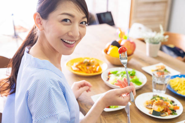 istock asian woman who eats 1292967526