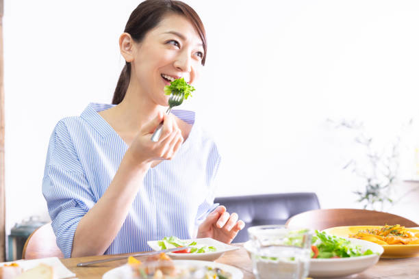 istock asian woman who eats 1292967576