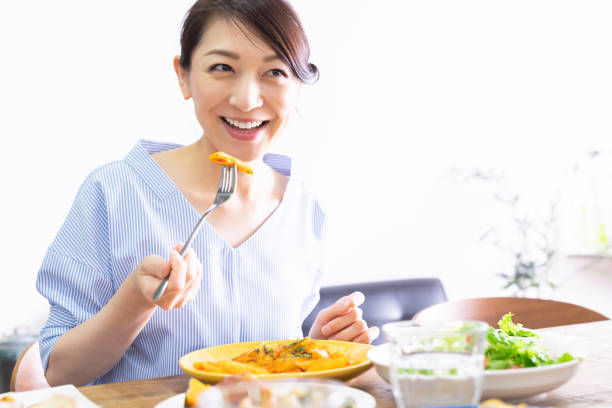 istock asian woman who eats 1292967579