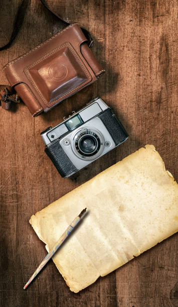 istock Still life flat lay retro camera with empty paper and Still life flat lay retro camera pipe book and quill pen 1292968309