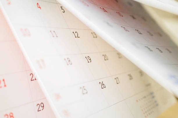 istock Calendar page flipping sheet close up on office table background business schedule planning appointment meeting concept 1292968351