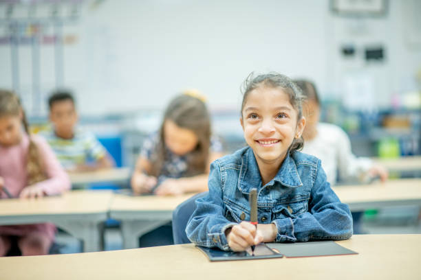 istock Young mixed race girl in classroom 1292968413