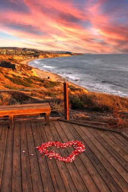 Photo of Sunset over Crystal Cove State Park Beach and a heart of rose petals