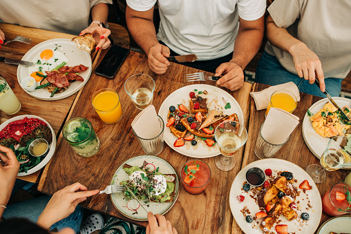 Grupo de personas desayunando o brunch en la mesa en la cafetería photo