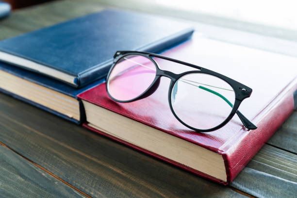 istock Reading glasses put on hardcover books 1292986024